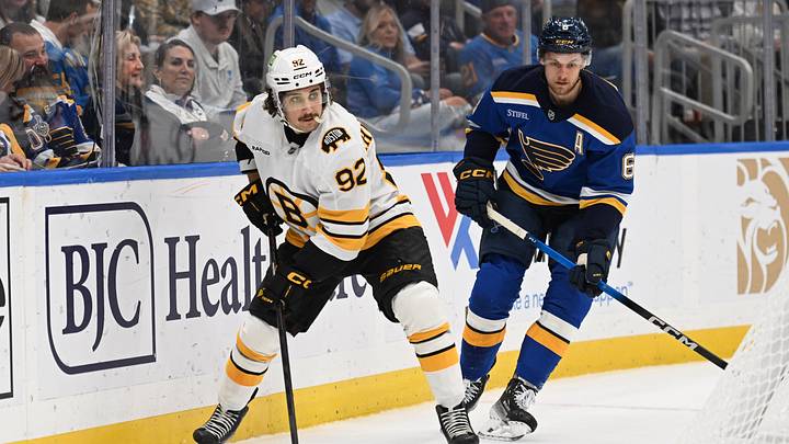 Oct 29, 2026; St. Louis, Missouri, USA;  St. Louis Blues defenseman Philip Broberg (6) pressures Boston Bruins center Marat Khusnutdinov (92) in the first period at Enterprise Center.  Mandatory Credit: Joe Puetz-Imagn Images