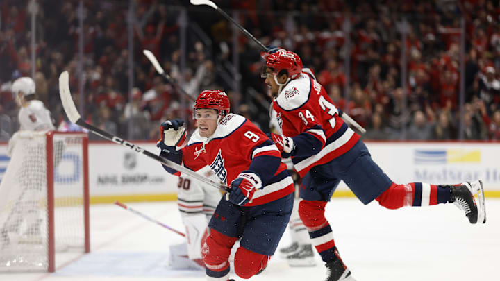 Jan 3, 2026; Washington, District of Columbia, USA; Washington Capitals right wing Ryan Leonard (9) celebrates with Capitals right wing Justin Sourdif (34) after scoring a goal Chicago Blackhawks goaltender Spencer Knight (30) during the third period at Capital One Arena. Mandatory Credit: Geoff Burke-Imagn Images