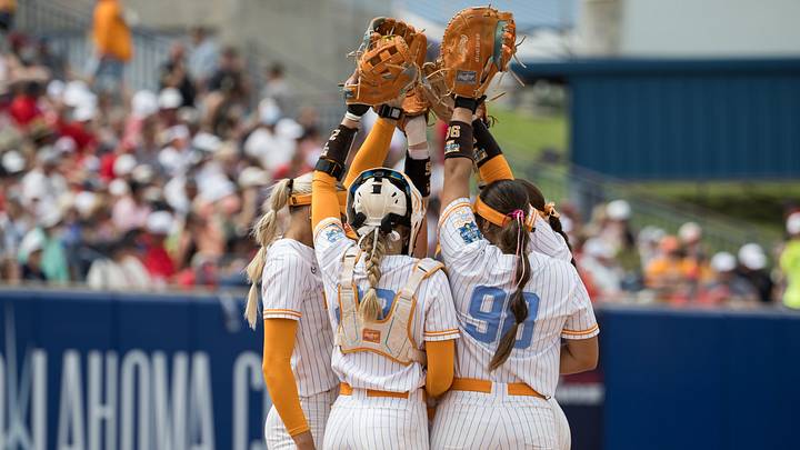 May 30, 2026; Oklahoma City, OK, USA;  the Tennessee Lady Volunteers infielders raise their gloves before the start of the sixth inning against the Texas Tech Red Raiders during the NCAA Women’s College World Series at Devon Park. Mandatory Credit: Brett Rojo-Imagn Images