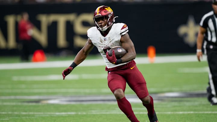 Dec 15, 2024; New Orleans, Louisiana, USA; Washington Commanders running back Brian Robinson Jr. (8) runs against the New Orleans Saints during the first half at Caesars Superdome. 