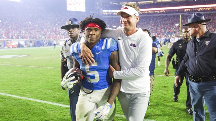 Nov 15, 2025; Oxford, Mississippi, USA; Mississippi Rebels head coach Lane Kiffin embraces running back Kewan Lacy (5) after defeating the Florida Gators at Vaught-Hemingway Stadium. Mandatory Credit: Petre Thomas-Imagn Images