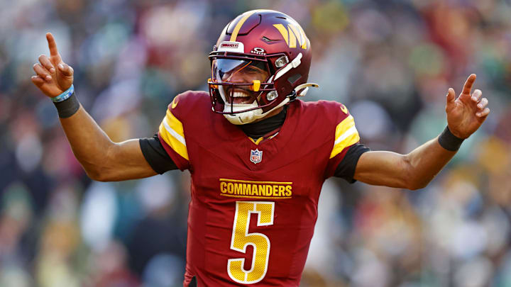 Dec 22, 2024; Landover, Maryland, USA; Washington Commanders quarterback Jayden Daniels (5) celebrates after throwing a touchdown during the fourth quarter against the Philadelphia Eagles at Northwest Stadium. Mandatory Credit: Peter Casey-Imagn Images