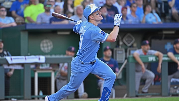 May 10, 2025; Kansas City, Missouri, USA;  Kansas City Royals left fielder Mark Canha (21) hits an RBI single in the third inning agaisnt the Boston Red Sox at Kauffman Stadium. Mandatory Credit: Peter Aiken-Imagn Images