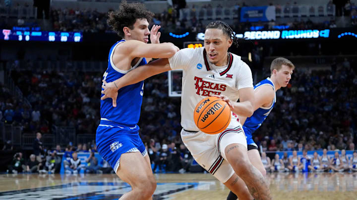 Mar 22, 2025; Wichita, KS, USA; Texas Tech Red Raiders forward Darrion Williams (5) dribbles the ball against Drake Bulldogs forward Daniel Abreu (54) during the second half at Intrust Bank Arena. Mandatory Credit: Kirby Lee-Imagn Images