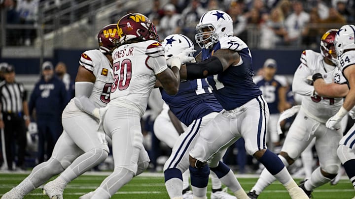 Nov 23, 2023; Arlington, Texas, USA; Washington Commanders defensive end Andre Jones Jr. (50) and Dallas Cowboys offensive tackle Tyron Smith (77) in action during the game between the Dallas Cowboys and the Washington Commanders at AT&T Stadium. Mandatory Credit: Jerome Miron-Imagn Images