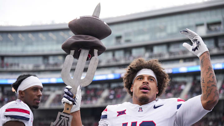 Nov 15, 2025; Cincinnati, Ohio, USA;  Arizona Wildcats defensive back Dalton Johnson (43) celebrates on the sidelines after intercepting a pass against the Cincinnati Bearcats in the first half at Nippert Stadium. Mandatory Credit: Aaron Doster-Imagn Images