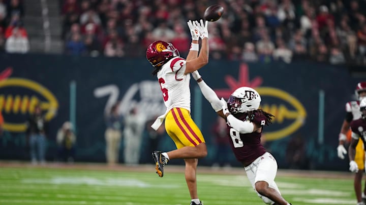 Southern California Trojans wide receiver Makai Lemon (6) catches the ball against Texas A&M Aggies defensive back Jaydon Hill (8) in the second half at Allegiant Stadium.