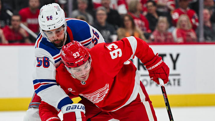 Apr 5, 2024; Detroit, Michigan, USA; Detroit Red Wings right wing Alex DeBrincat (93) brings the puck up ice as New York Rangers defenseman Ryan Lindgren (55) defends during the second period at Little Caesars Arena. Mandatory Credit: Tim Fuller-Imagn Images