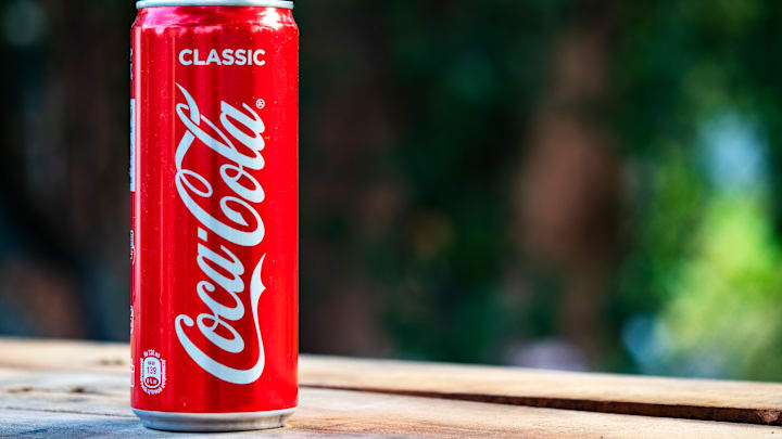 In this photo illustration a Coca-Cola can seen displayed on...