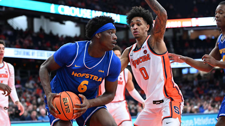 Dec 13, 2025; Syracuse, New York, USA; Hofstra Pride forward Victory Onuetu (6) drives against Syracuse Orange forward Sadiq White Jr. (0) in the first half at the JMA Wireless Dome. Mandatory Credit: Mark Konezny-Imagn Images