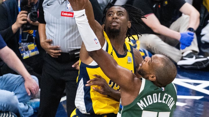 Apr 28, 2024; Indianapolis, Indiana, USA; Indiana Pacers forward Aaron Nesmith (23) blocks the shot of Milwaukee Bucks forward Khris MIddleont (22).