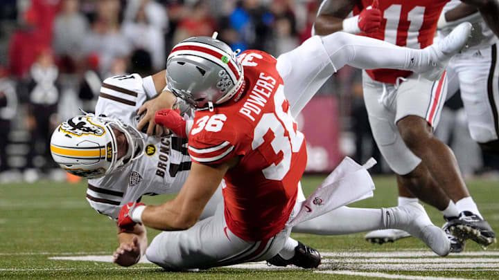 Sept. 7, 2024; Columbus, Ohio, USA;
Western Michigan Broncos quarterback Broc Lowry (14) is tackled by Ohio State Buckeyes linebacker Gabe Powers (36) during the second half of an NCAA Division I football game on Saturday at Ohio Stadium.