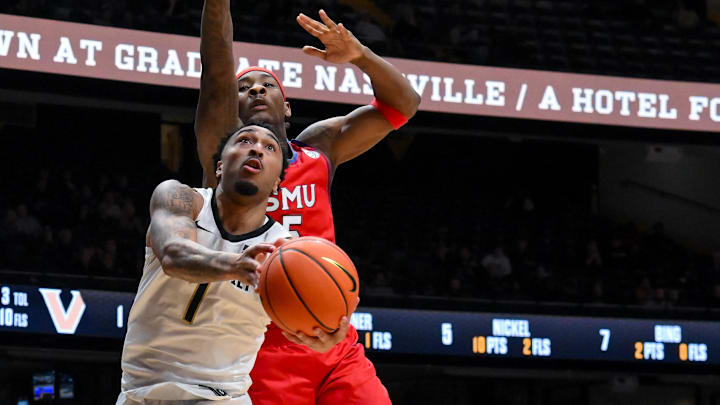 Dec 3, 2025; Nashville, Tennessee, USA;  Vanderbilt Commodores guard Frankie Collins (1) goes up and under the arm of Southern Methodist University Mustangs guard B.J. Edwards (0) during the second half at Memorial Gymnasium. Mandatory Credit: Steve Roberts-Imagn Images