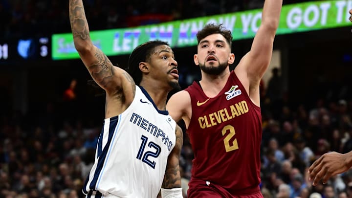 Feb 23, 2025; Cleveland, Ohio, USA; Memphis Grizzlies guard Ja Morant (12) drives to the basket against Cleveland Cavaliers guard Ty Jerome (2) and forward Evan Mobley (4) during the second half at Rocket Arena. Mandatory Credit: Ken Blaze-Imagn Images Feb 23, 2025; Cleveland, Ohio, USA; Memphis Grizzlies guard Ja Morant (12) drives to the basket against Cleveland Cavaliers guard Ty Jerome (2) and forward Evan Mobley (4) during the second half at Rocket Arena. Mandatory Credit: Ken Blaze-Imagn Images