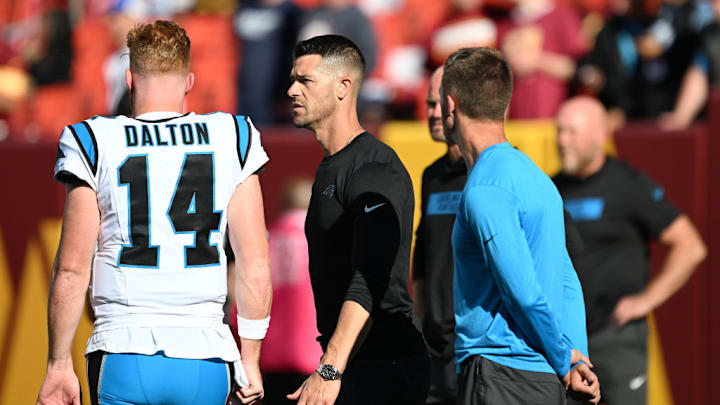 LANDOVER, MARYLAND - OCTOBER 20: Andy Dalton #14 of the Carolina Panthers talks with head coach Dave Canales of the Carolina Panthers prior to the game against the Washington Commanders at FedExField on October 20, 2024 in Landover, Maryland. LANDOVER, MARYLAND - OCTOBER 20: Andy Dalton #14 of the Carolina Panthers talks with head coach Dave Canales of the Carolina Panthers prior to the game against the Washington Commanders at FedExField on October 20, 2024 in Landover, Maryland.