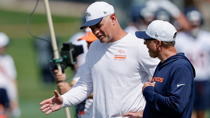 Jul 24, 2025; Englewood, CO, USA; Denver Broncos offensive coordinator Joe Lombardi (L) and offensive assistant Pete Carmichael (R) during Denver Broncos Training Camp. 