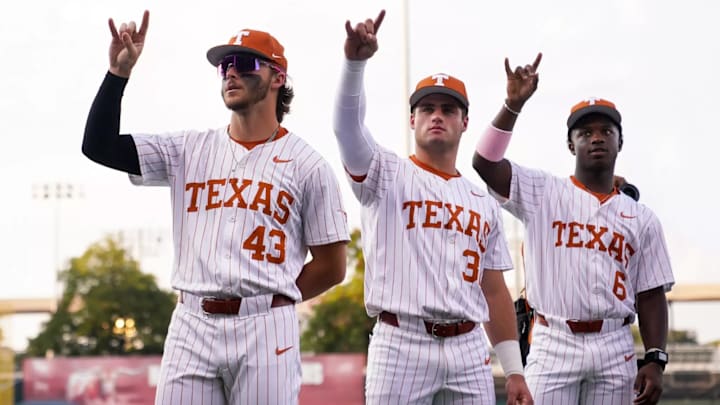 Texas Longhorns Aiden Robbins, Casey Borba and Anthony Pack Jr. throw up the Hook 'Em Horns.