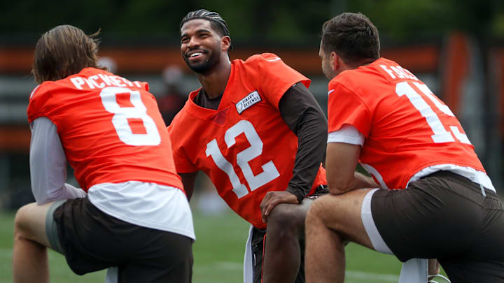 Browns quarterbacks Shedeur Sanders (12), Kenny Pickett (8) and Joe Flacco (15) talk during minicamp June 10, 2025, in Berea, Ohio.
