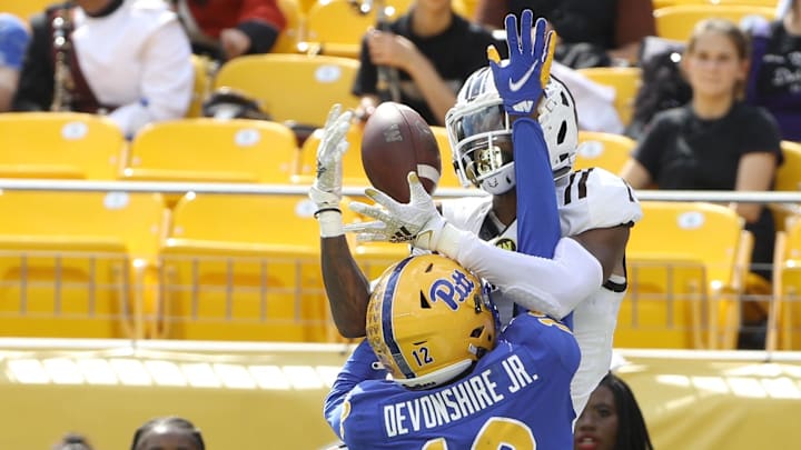 Western Michigan Broncos cornerback Jeremiah Piper (in white) tries to intercept pass. Western Michigan Broncos cornerback Jeremiah Piper (in white) tries to intercept pass.