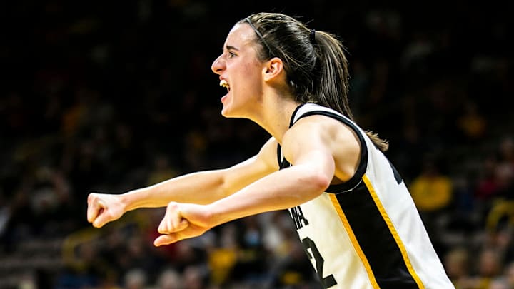 Iowa guard Caitlin Clark cheers on teammates during a NCAA Big Ten Conference women's basketball game