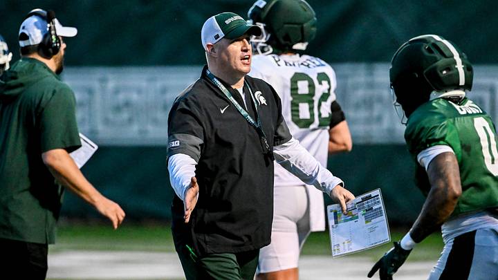 Michigan State's head coach Pat Fitzgerald, left, slaps hands with NiJhay Burt during spring football practice on Tuesday, April 14, 2026, in East Lansing. Michigan State's head coach Pat Fitzgerald, left, slaps hands with NiJhay Burt during spring football practice on Tuesday, April 14, 2026, in East Lansing.
