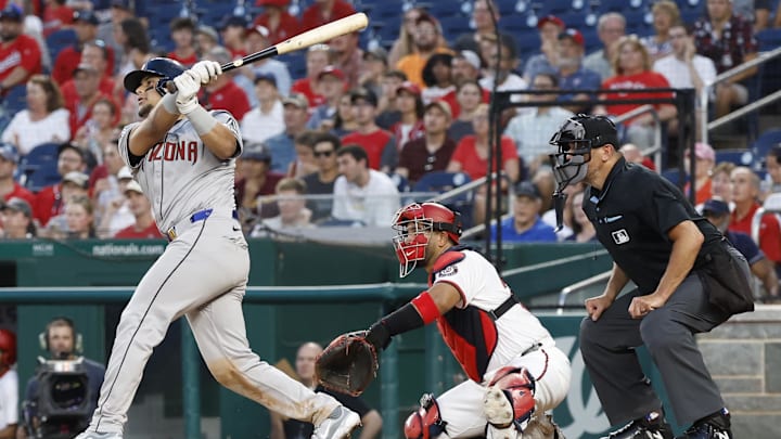Jun 18, 2024; Washington, District of Columbia, USA; Arizona Diamondbacks catcher Gabriel Moreno (14) hits a sacrifice fly RBI against the Washington Nationals during the sixth inning at Nationals Park. Mandatory Credit: Geoff Burke-USA TODAY Sports