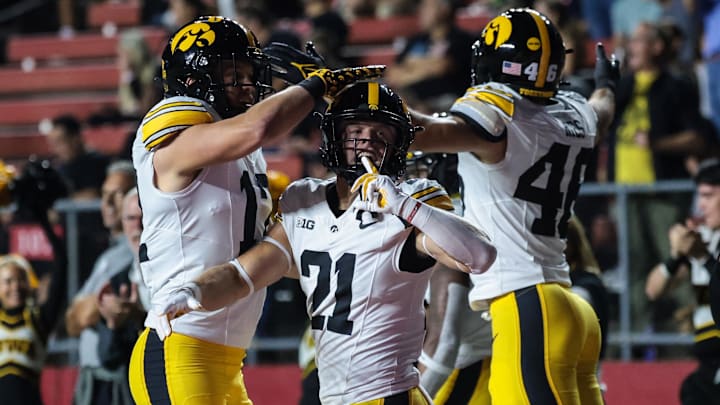 Sep 19, 2025; Piscataway, New Jersey, USA; Iowa Hawkeyes wide receiver Kaden Wetjen (21) celebrates with teammates after returning the opening kick off for a touchdown during the first quarter against the Rutgers Scarlet Knights at SHI Stadium. Mandatory Credit: Vincent Carchietta-Imagn Images