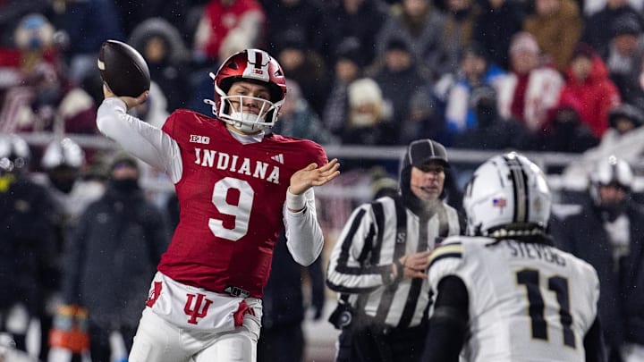 Nov 30, 2024; Bloomington, Indiana, USA; Indiana Hoosiers quarterback Kurtis Rourke (9) passes the ball while Purdue Boilermakers defensive back Antonio Stevens (11) defends in the first half at Memorial Stadium. Mandatory Credit: Trevor Ruszkowski-Imagn Images Nov 30, 2024; Bloomington, Indiana, USA; Indiana Hoosiers quarterback Kurtis Rourke (9) passes the ball while Purdue Boilermakers defensive back Antonio Stevens (11) defends in the first half at Memorial Stadium. Mandatory Credit: Trevor Ruszkowski-Imagn Images