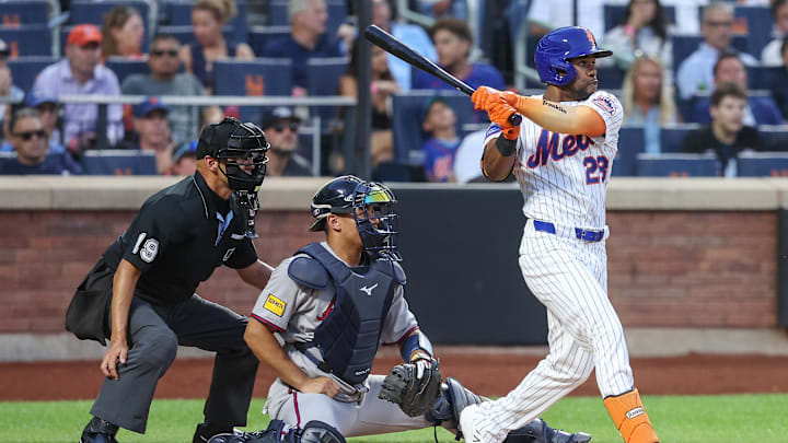 Aug 12, 2025; New York City, New York, USA;  New York Mets center fielder Cedric Mullins (28) hits an RBI single in the second inning against the Atlanta Braves at Citi Field. Mandatory Credit: Wendell Cruz-Imagn Images