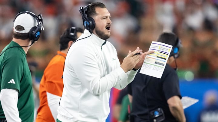 Jan 8, 2026; Glendale, AZ, USA; Miami Hurricanes tight ends coach Cody Woodiel against the Mississippi Rebels during the 2026 Fiesta Bowl and semifinal game of the College Football Playoff at State Farm Stadium. Mandatory Credit: Mark J. Rebilas-Imagn Images Jan 8, 2026; Glendale, AZ, USA; Miami Hurricanes tight ends coach Cody Woodiel against the Mississippi Rebels during the 2026 Fiesta Bowl and semifinal game of the College Football Playoff at State Farm Stadium. Mandatory Credit: Mark J. Rebilas-Imagn Images
