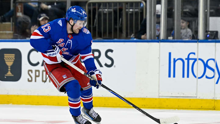 Mar 10, 2026; New York, New York, USA;  New York Rangers left wing Alexis Lafrenière (13) skates across center ice against the Calgary Flames during the third period at Madison Square Garden. Mandatory Credit: Dennis Schneidler-Imagn Images