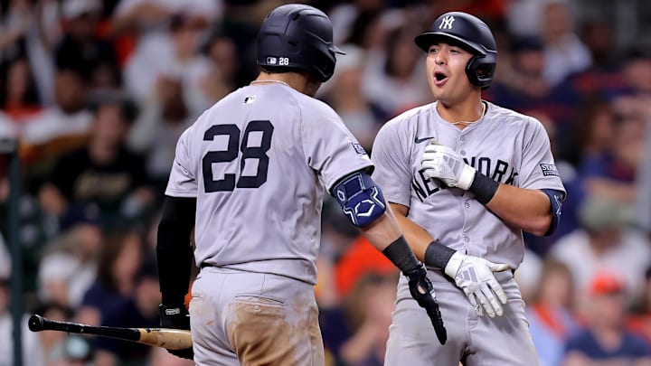 Mar 30, 2024; Houston, Texas, USA; New York Yankees shortstop Anthony Volpe (11) is congratulated by New York Yankees catcher Austin Wells (28) after hitting a home run against the Houston Astros during the eighth inning at Minute Maid Park.