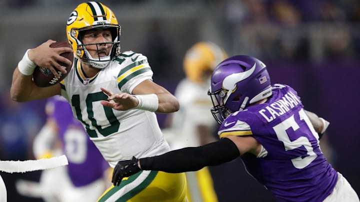 Green Bay Packers quarterback Jordan Love (10) is tackled by Minnesota Vikings linebacker Blake Cashman (51) in the fourth quarter during their football game Sunday, December 29, 2024, at U.S. Bank Stadium in Minneapolis, Minnesota.