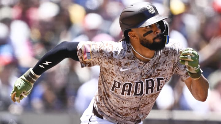 Jul 13, 2025; San Diego, California, USA; San Diego Padres right fielder Fernando Tatis Jr. (23) hits a single during the first inning against the against the Philadelphia Phillies at Petco Park. Mandatory Credit: Denis Poroy-Imagn Images