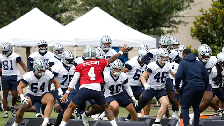Dallas Cowboys quarterback Dak Prescott leads teammates through a drill at the Ford Center at the Star Training Facility