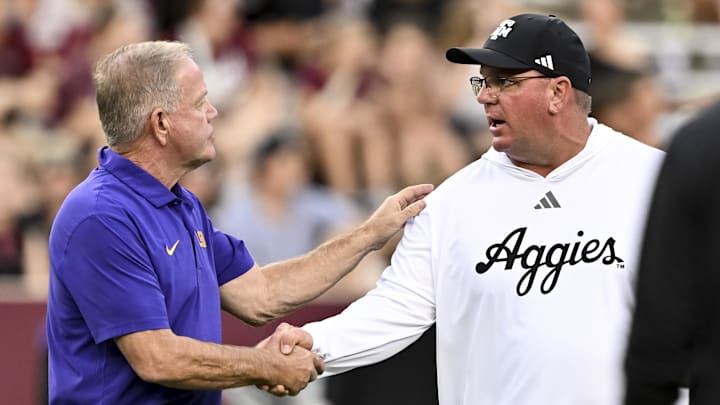 Oct 26, 2024; College Station, Texas, USA; .LSU Tigers head coach Brian Kelly, left, and Texas A&M Aggies head coach Mike Elko, right, greet prior to the game at Kyle Field. Mandatory Credit: Maria Lysaker-Imagn Images. 