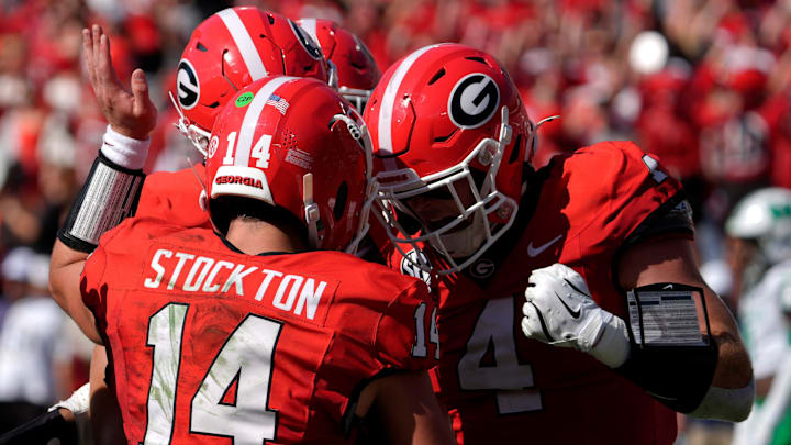 Georgia quarterback Gunner Stockton (14) celebrates with his teammates after scoring a touchdown during the first half of a NCAA college football game against Marshall in Athens, Ga., on Saturday, August. 30, 2025.