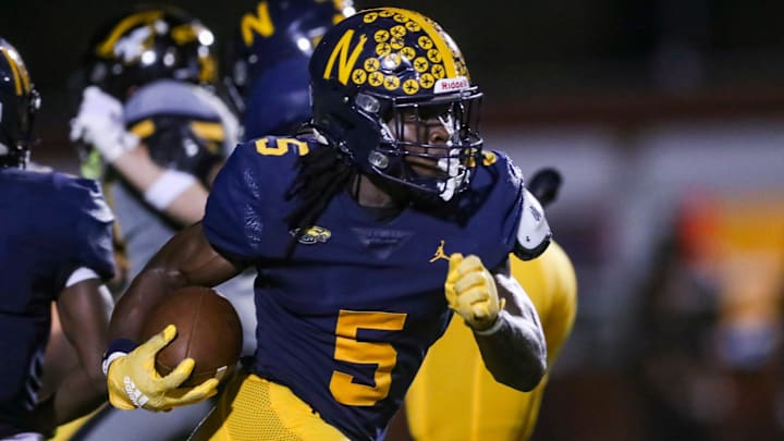 Naples Golden Eagles running back Shawn Simeon (5) returns a kick during the third quarter of a game against the American Heritage Patriots at Staver Field in Naples on Friday, Sept. 13, 2024.