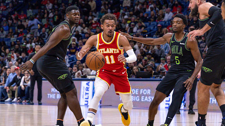 Atlanta Hawks guard Trae Young (11) brings the ball up court around New Orleans Pelicans forward Zion Williamson (1) and forward Herbert Jones (5) during the first half at Smoothie King Center. Mandatory Credit: Stephen Lew-Imagn Images