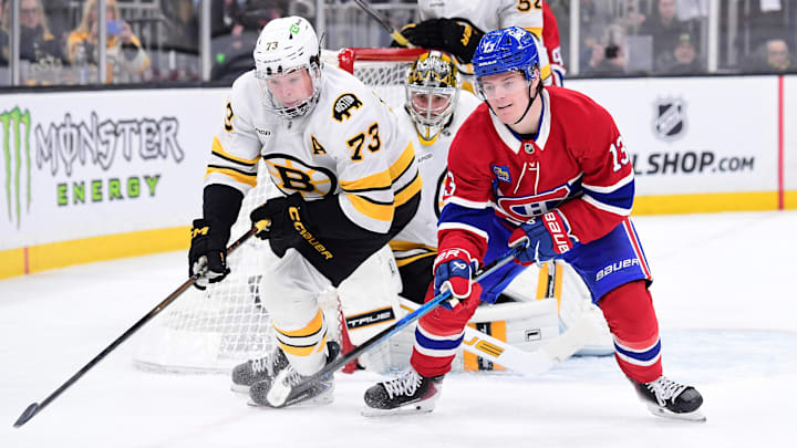 Jan 24, 2026; Boston, Massachusetts, USA; Boston Bruins defenseman Charlie McAvoy (73) and Montreal Canadiens right wing Cole Caufield (13) battle for the puck during the second period at TD Garden. Mandatory Credit: Bob DeChiara-Imagn Images