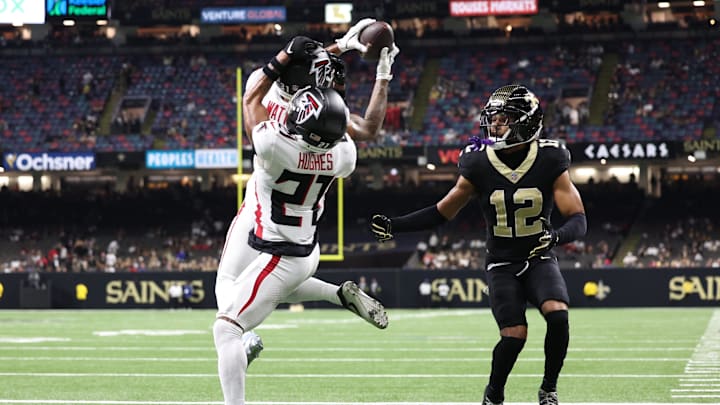 Nov 23, 2025; New Orleans, Louisiana, USA; Atlanta Falcons safety Xavier Watts (31) makes the interception in front of teammate cornerback Mike Hughes (21) and New Orleans Saints wide receiver Chris Olave (12) during the second half at Caesars Superdome. Mandatory Credit: Stephen Lew-Imagn Images