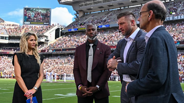 Oct 5, 2024; College Station, Texas, USA; SEC Nation host Laura Rutledge, analyst Roman Harper, analyst Tim Tebow and analyst Paul Finebaum speak prior to the game between the Texas A&M Aggies and the Missouri Tigers at Kyle Field. Mandatory Credit: Maria Lysaker-Imagn Images. 