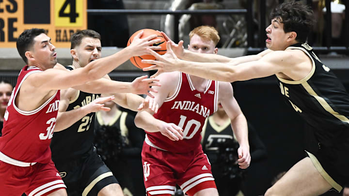 Indiana guard Trey Galloway (32) and Purdue forward Raleigh Burgess (34) go after a loose ball at Mackey Arena. Indiana guard Trey Galloway (32) and Purdue forward Raleigh Burgess (34) go after a loose ball at Mackey Arena.