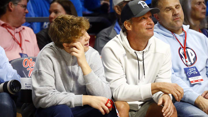 Mississippi Rebels head football coach Lane Kiffin (right) sits court-side with his son Knox Kiffin (left) during the second half between the Mississippi State Bulldogs and the Mississippi Rebels.