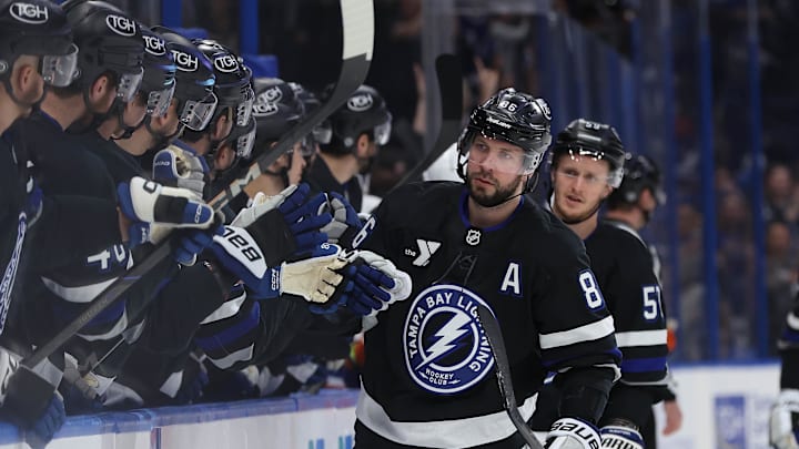 Mar 29, 2025; Tampa, Florida, USA; Tampa Bay Lightning right wing Nikita Kucherov (86) is congratulated by teammates after he scored a goal against the New York Islanders during the first period at Amalie Arena. Mandatory Credit: Kim Klement Neitzel-Imagn Images