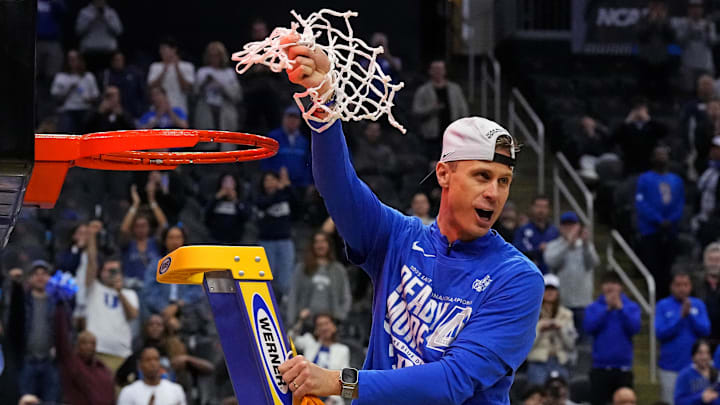 Mar 29, 2025; Newark, NJ, USA; Duke Blue Devils head coach Jon Scheyer cuts down the net after the Duke Blue Devils beat the Alabama Crimson Tide in the East Regional final.