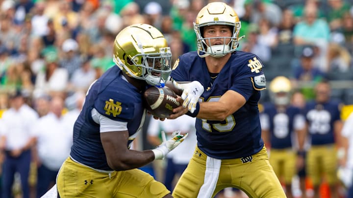 Sep 20, 2025; South Bend, Indiana, USA; Notre Dame Fighting Irish quarterback CJ Carr (13) hands off to Notre Dame Fighting Irish running back Jeremiyah Love (4) against the Purdue Boilermakers during the first half at Notre Dame Stadium. Mandatory Credit: Michael Caterina-Imagn Images