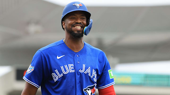 Toronto Blue Jays designated hitter Eloy Jimenez (74) smiles after he checks on the balls and strikes. Toronto Blue Jays designated hitter Eloy Jimenez (74) smiles after he checks on the balls and strikes.