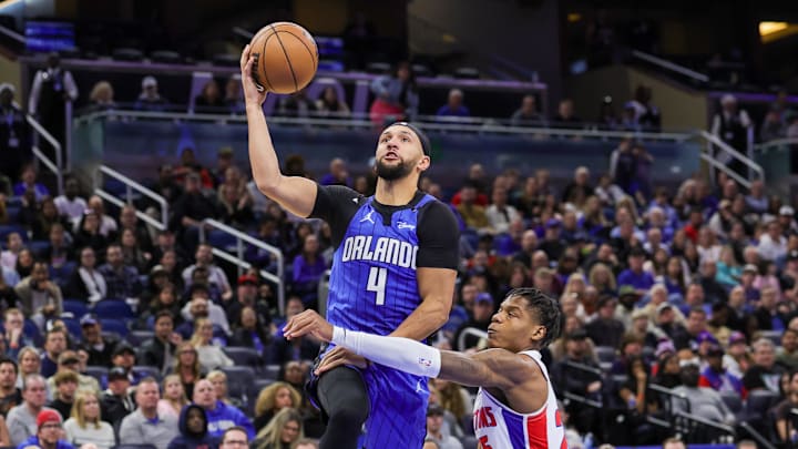 Orlando Magic guard Jalen Suggs (4) is fouled by Detroit Pistons guard Marcus Sasser (25) during the second half at Kia Center.