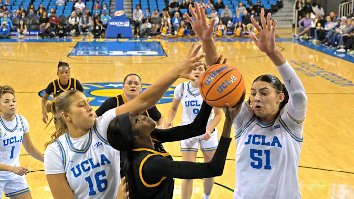 Dec 20, 2025; Los Angeles, California, USA; UCLA Bruins forward Sienna Betts (16) and center Lauren Betts (51) defend a shot by Long Beach State Beach forward Rosie Akot (2) during the second half at Pauley Pavilion presented by Wescom Financial. Mandatory Credit: Jayne Kamin-Oncea-Imagn Images
